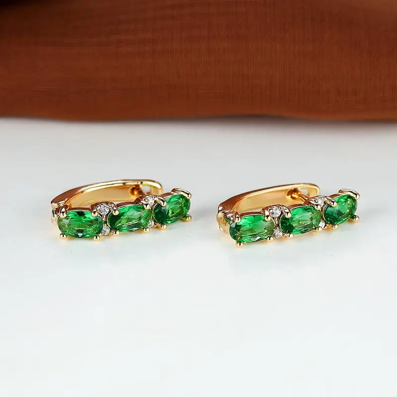 Boucles d'oreilles créoles verticales en or et émeraude