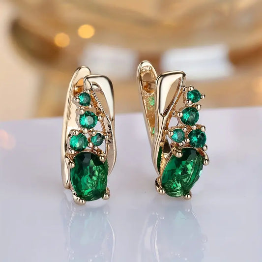 Boucles d'oreilles pendantes en or et émeraudes