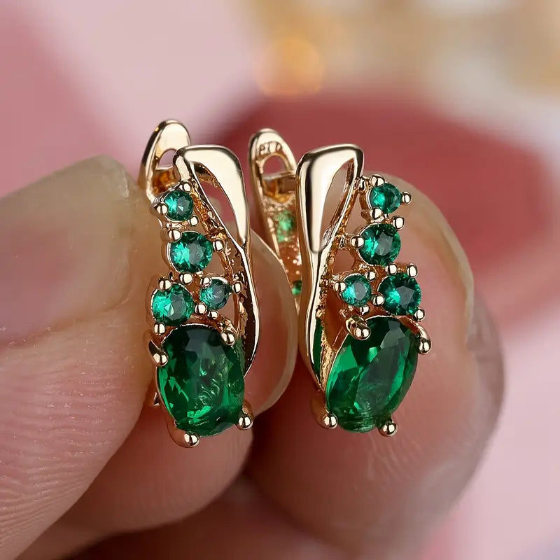 Boucles d'oreilles pendantes en or et émeraudes