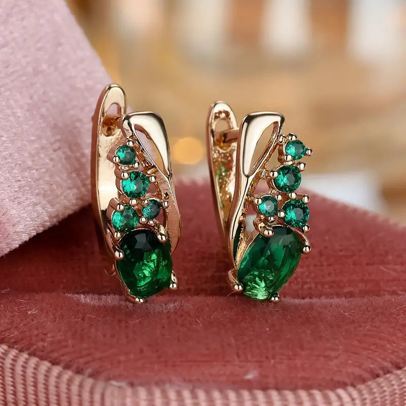 Boucles d'oreilles pendantes en or et émeraudes